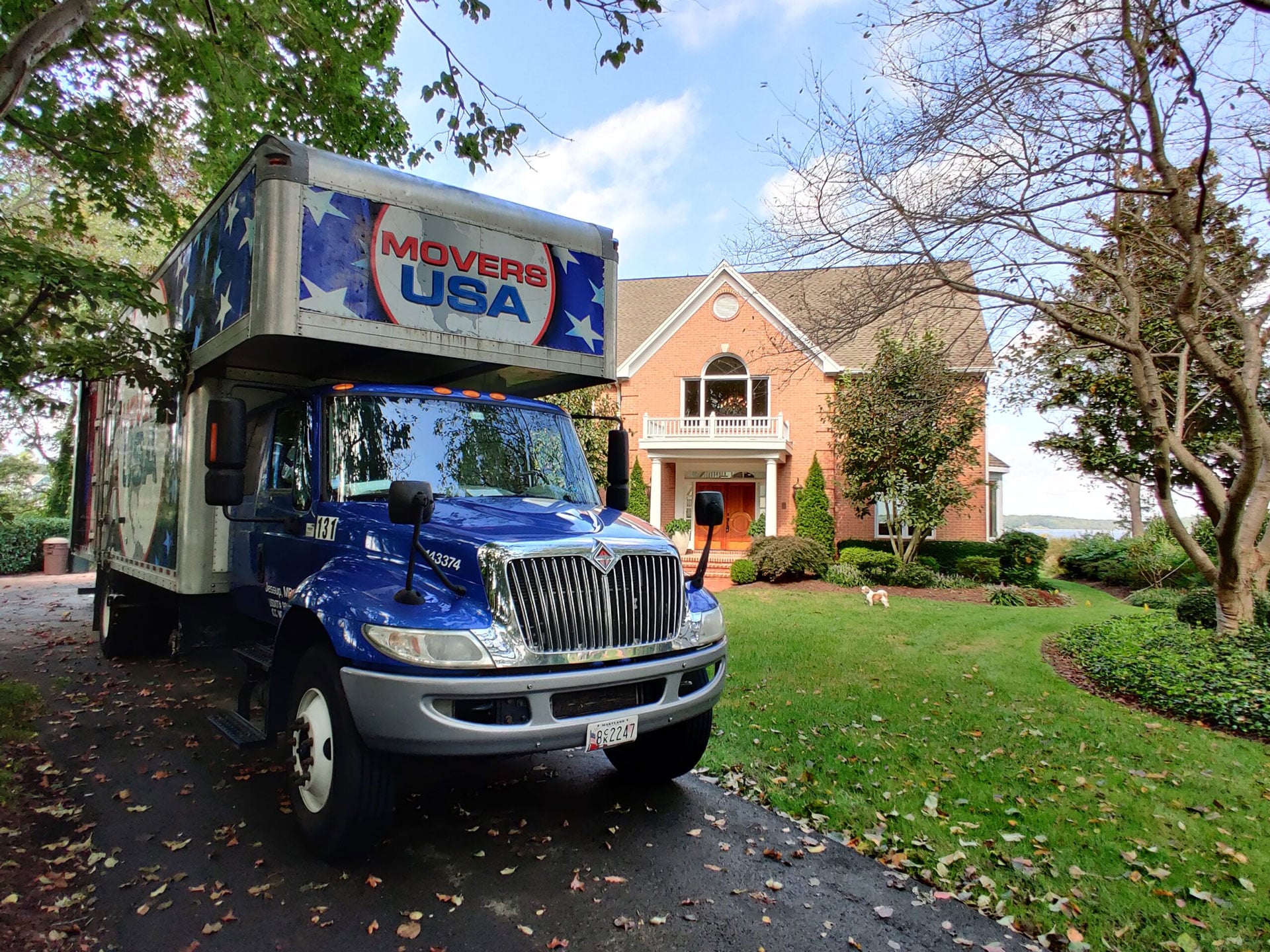Movers USA truck on suburban residential street