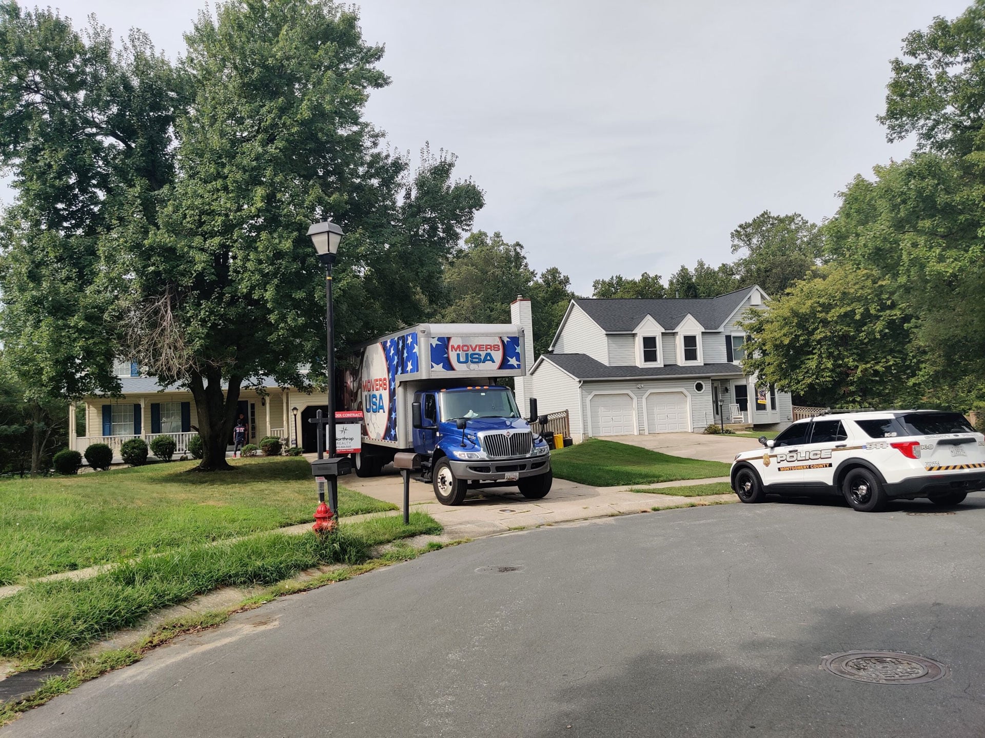 Movers USA moving truck and police car